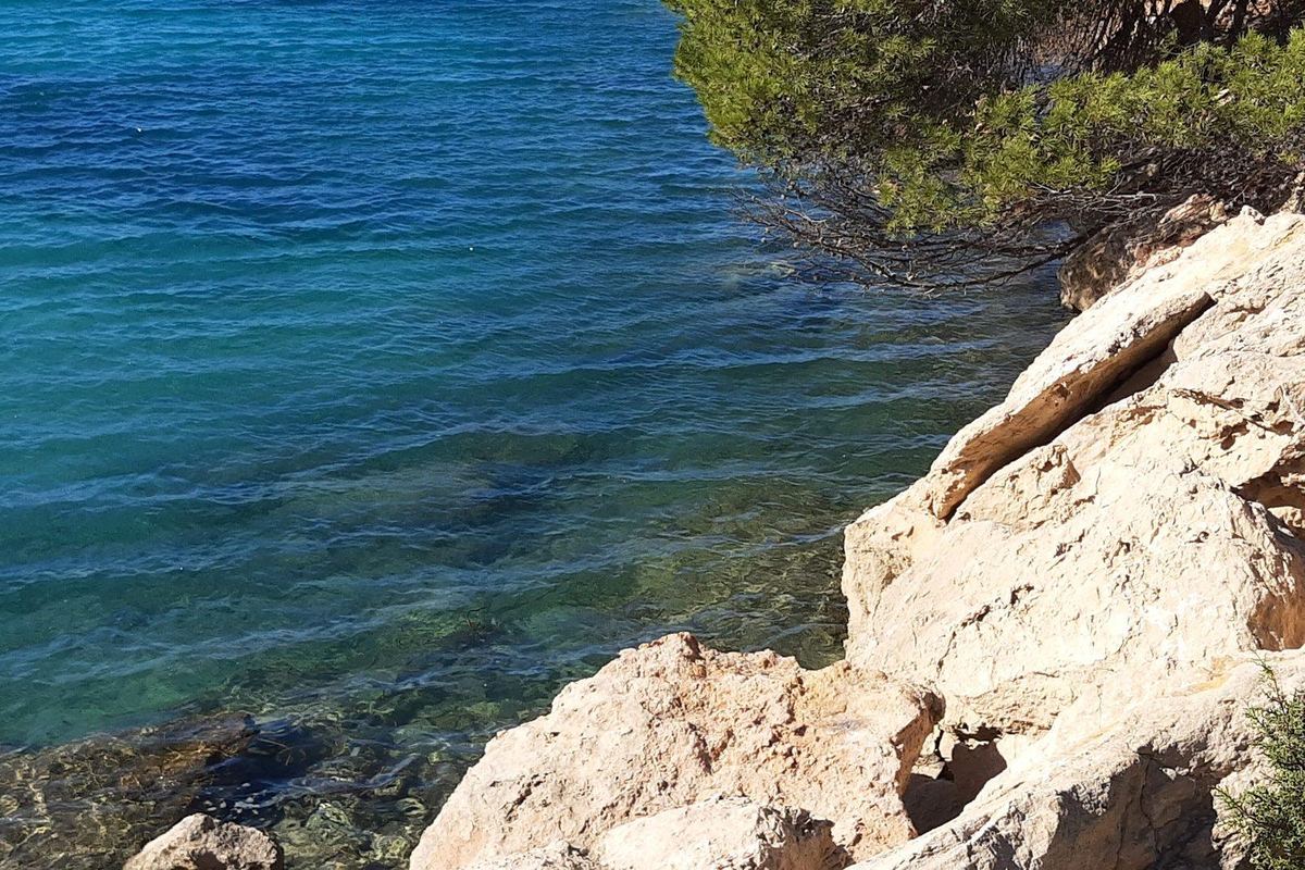 Clear water over the rocks at Port des Torrent
