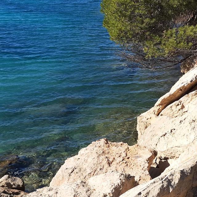 Clear water over the rocks at Port des Torrent
