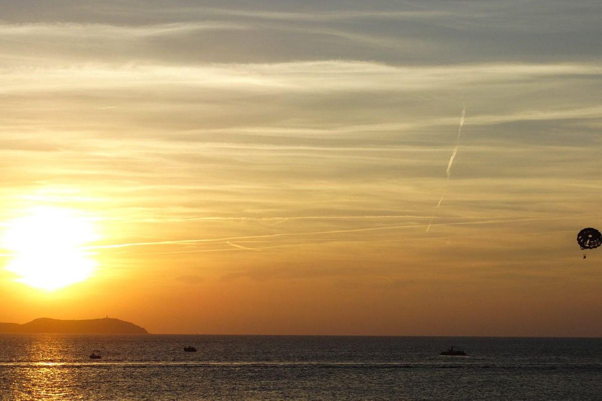 The sun setting over the sea and islets off Sant Antoni