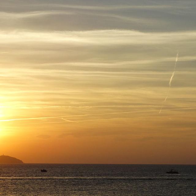 The sun setting over the sea and islets off Sant Antoni