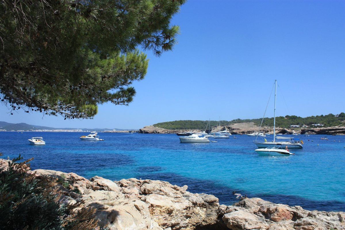 Rocky shore and turquoise bay on Ibiza’s west coast
